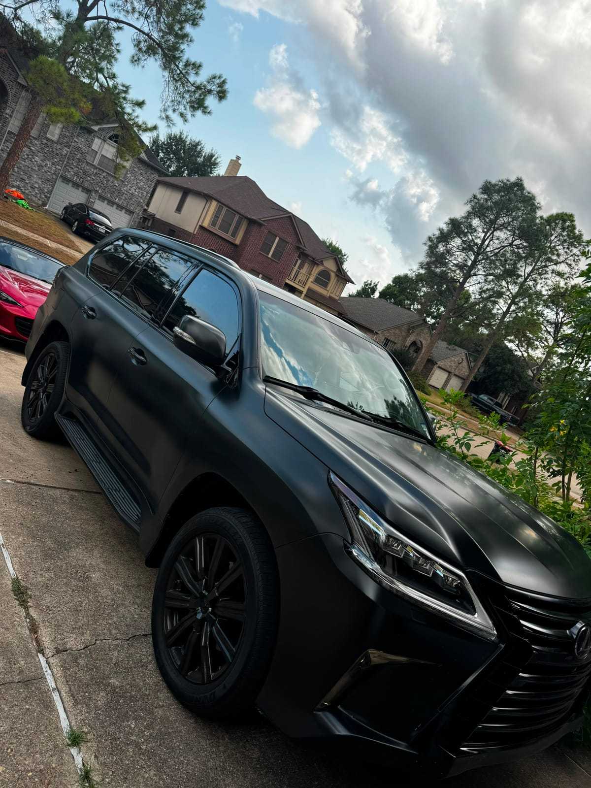 Matte black Lexus LX 570 SUV with dark window tint